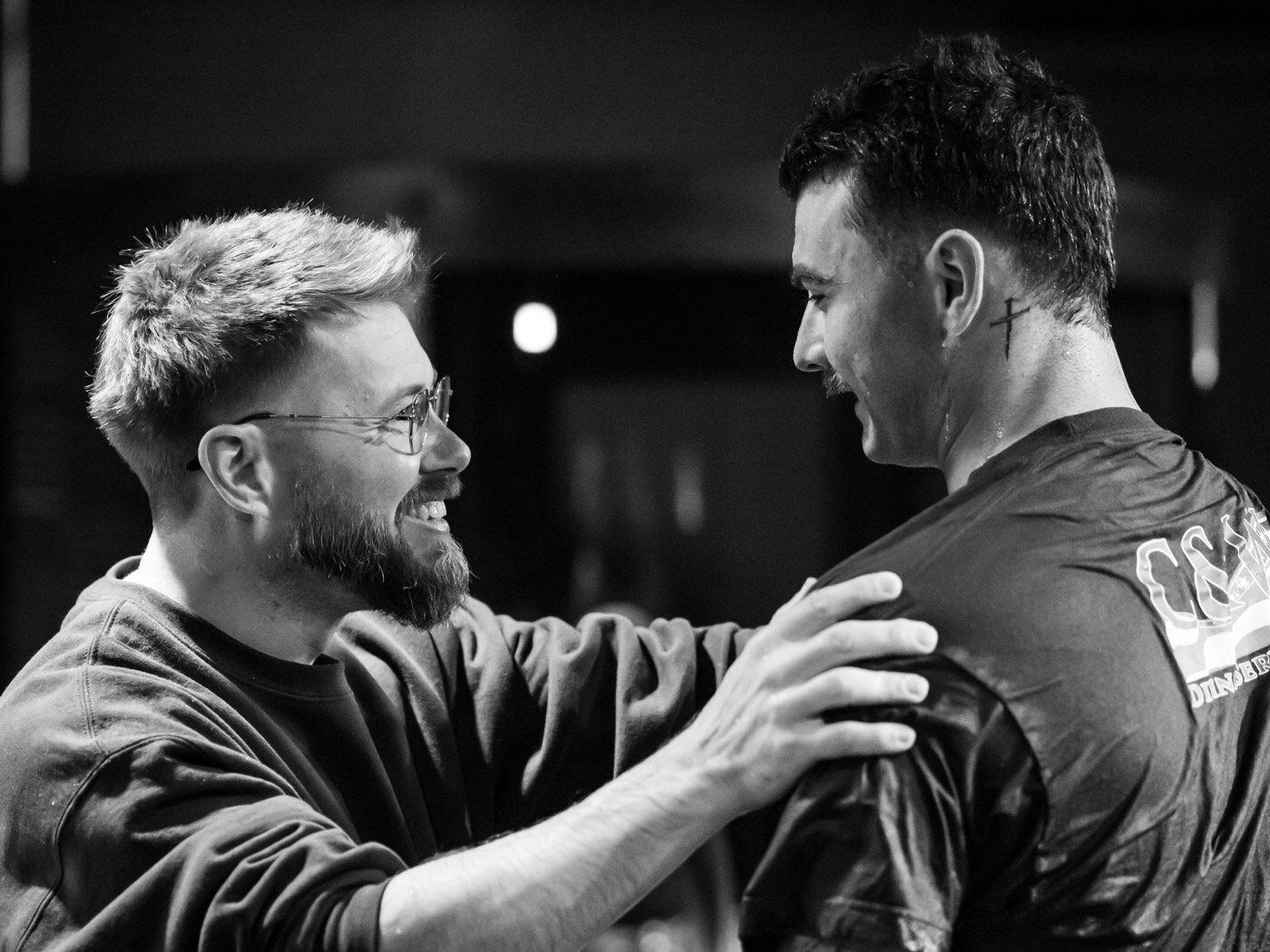 Pastor congratulating a man after his baptism at Overflow Worship Center